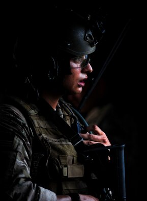 Senior Airman Ricardo Maggin, 1st Special Operations Security Forces Squadron deployed aircraft ground response element team member, communicates with his team during a task force exercise on Eglin Range Complex, Fla., July 27, 2015. Exercise scenarios included downed aircraft site security and armed escort. Through the scenarios, DAGRE was able to accomplish multiple training objectives including close quarters combat, small unit tactics, flight deck denial, fly away security, close air support, casualty evacuation and more. (U.S. Air Force photo by Senior Airman Meagan Schutter)