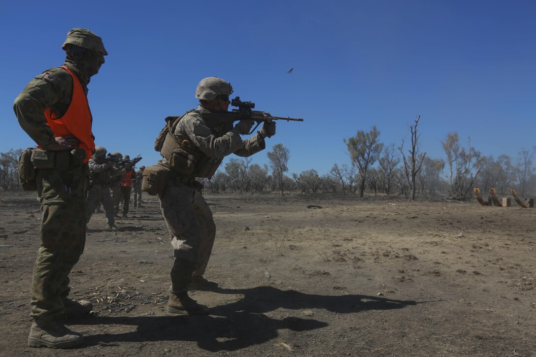 U.S. Marine Corps Cpl. George Gilbert shoots a F88 Austeyr assault rifle during a static live-fire range July 4 as part of Exercise Koolendong at Bradshaw Training Area, Northern Territory, Australia. Koolendong is a bilateral combined arms training exercise that combined light infantry, indirect fire weapons systems and air assets during training events. The rotational deployment of U.S. Marines in Darwin enables them to more effectively train, exercise, and operate with partners, enhances regional security and builds capacity to respond more rapidly to natural disasters and crises throughout that region. Gilbert is a team leader with Company A, 1st Battalion, 4th Marine Regiment, Marine Rotational Force – Darwin.