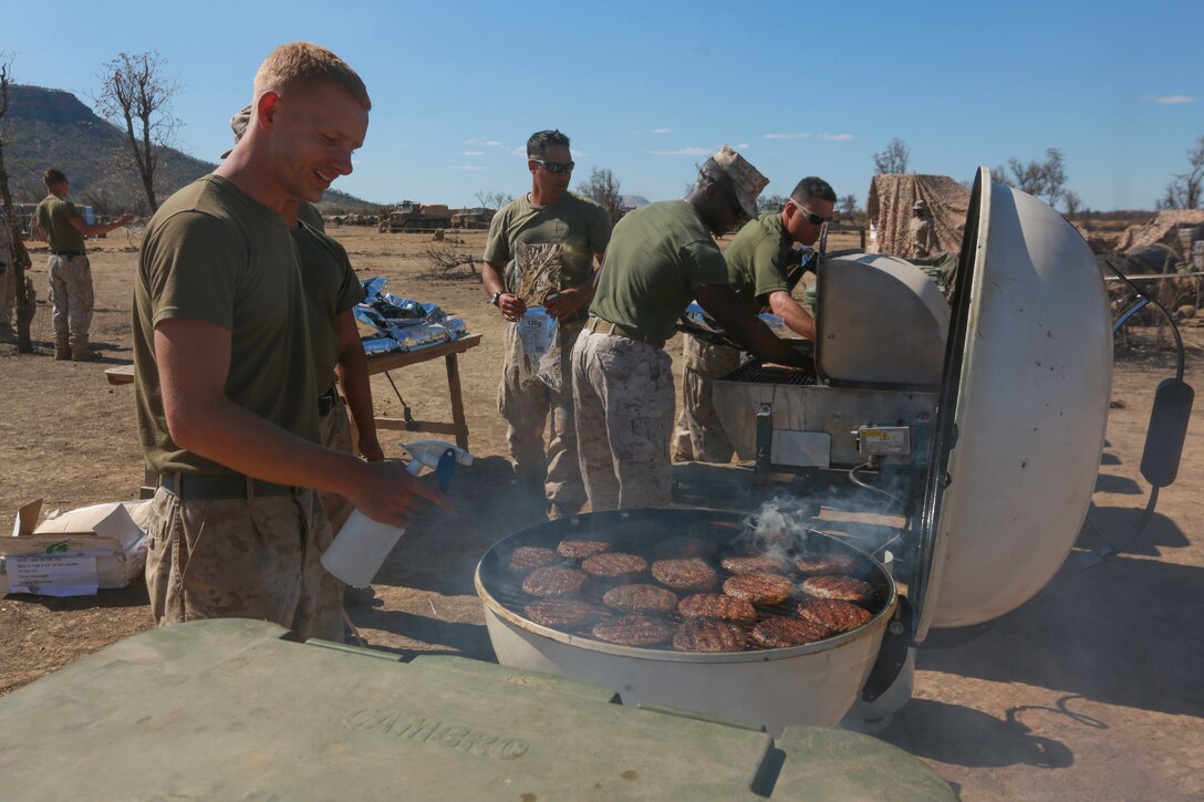 U.S. Marines with Marine Rotational Force – Darwin grill burgers and hotdogs for a Fourth of July celebration on July 5 to bring an end to Exercise Koolendong at Bradshaw Field Training Area, Northern Territory, Australia. Koolendong is a bilateral combined arms training exercise that combined light infantry, indirect fire weapons systems and air assets during training events. The rotational deployment of U.S. Marines in Darwin enables them to more effectively train, exercise, and operate with partners, enhances regional security and builds capacity to respond more rapidly to natural disasters and crises throughout that region.