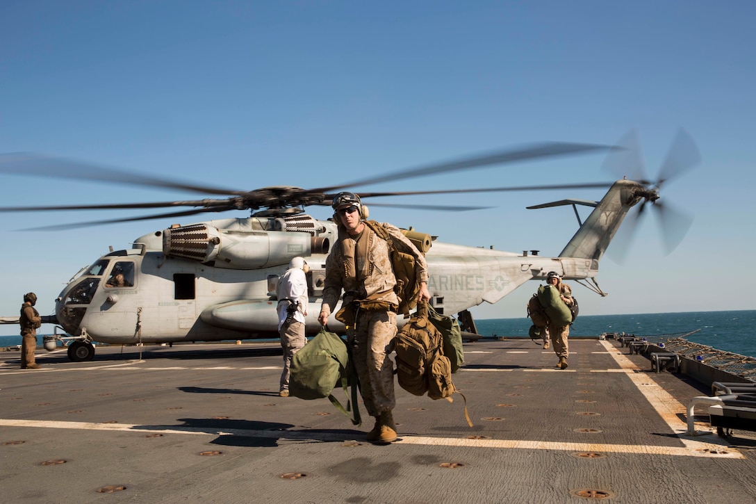U.S. Marines exit a CH-53E Super Stallion helicopter from Marine Heavy Helicopter Squadron 463, Marine Rotational Force – Darwin, after being transported aboard ship July 5 from the Royal Australian Air force Base Darwin, Darwin, Northern Territory, Australia to the USNS Sacagawea (T-AKE-2). Two CH-53Es conducted the ship-landing operation, carrying approximately 20 personnel and practicing ship landing and take-off. The Marines are able to operate from the combat operations center aboard the USNS Sacagawea in support of Talisman Sabre 2015, which is a major Australian and U.S. military training exercise focused on mid-intensity “high end” war fighting. The MRF-D six-month deployment demonstrates how the Marine Air Ground Task Force is equipped and organized to carry out national objectives in cooperation with our national and international partners.