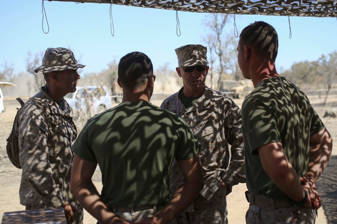 U.S. Marine Corps Brig. Gen. Paul J. Kennedy (back right) and Col. David L. Odom (back left) speak with Marines from 4th Marine Regiment during Exercise Talisman Sabre 2015 at Bradshaw Field Training Area, Northern Territory, Australia, July 8. Exercises such as Talisman Sabre 2015 provide realistic, relevant training which is necessary to maintain regional security, peace, and stability. Talisman Sabre provides an invaluable opportunity to conduct operations in a combined, joint, and interagency environment that increases the U.S.-Australian alliance’s ability to plan and execute contingency responses, from combat missions to humanitarian assistance efforts. Kennedy is the commanding general of 3rd Marine Expeditionary Brigade, III Marine Expeditionary Force. Odom is the commanding officer of 4th Marine Regiment, 3rd Marine Division, III MEF.