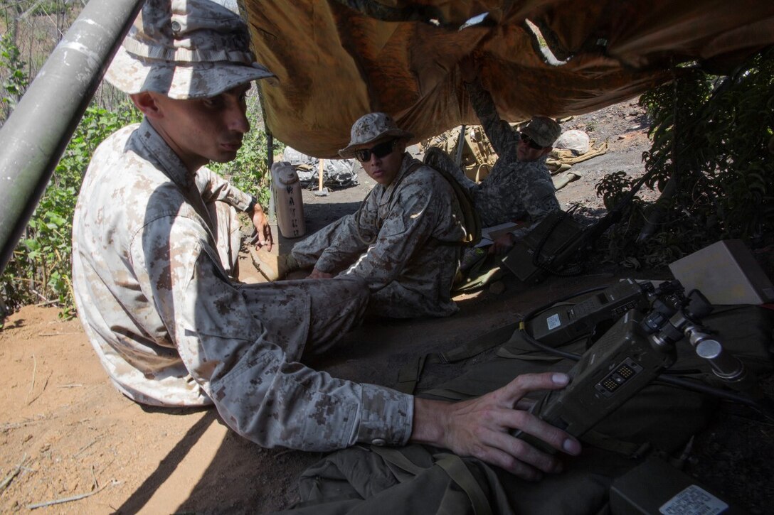 Marine Cpl. McKay Blackford, left, an electrical equipment engineer systems technician, and Lance Cpl. Juan Duran, center, a supply administrator, with 4th Air Naval Gunfire Liaison Company, Force Headquarters Group, Marine Corps Forces Reserve, train to support a radio retransmission point along with Army Spc. Ian Batson, a satellite communication specialist with 4th Joint Communications Squadron, Joint Communications Support Element (Airborne), U. S. Army Reserves, during Exercise Lightning Strike aboard Marine Corps Base Camp Pendleton, Calif., July 29, 2015. The service members trained with various forms of communication equipment including both voice and data transmission. (U.S. Marine Corps photo by Lance Cpl. Caitlin Bevel)