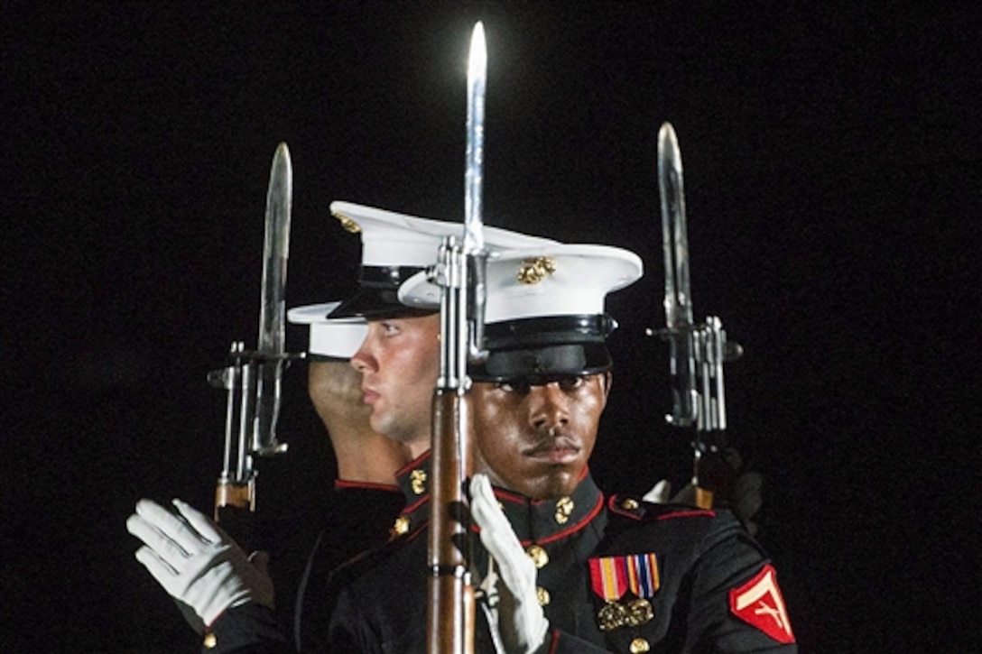 The Marine Corps Silent Drill Team performs during the evening parade at Marine Barracks Washington, D.C., July 31, 2015. Marine Corps Commandant Gen. Joseph F. Dunford Jr. hosted the event and Army Gen. Martin E. Dempsey, chairman of the Joint Chiefs of Staff, was the guest of honor. SILENT DRILLDoD photo by D. Myles Cullen