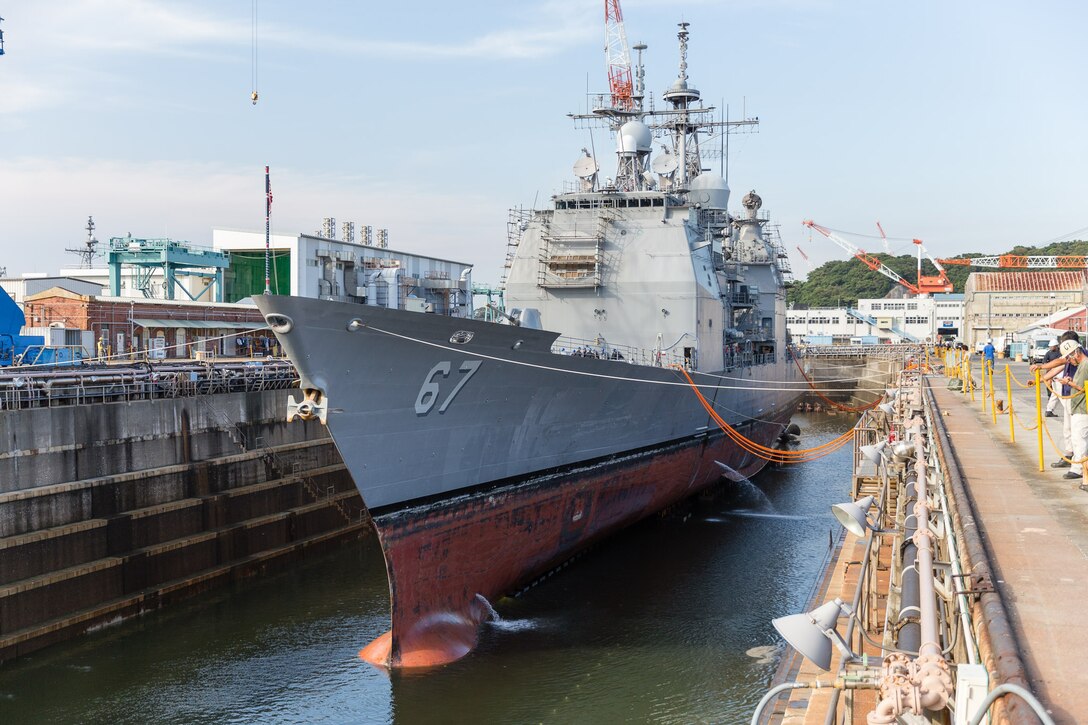 Water is drained from a dry dock as the guided-missile cruiser USS Shiloh prepares for  scheduled maintenance availability in Yokosuka, Japan, July 29, 2015.