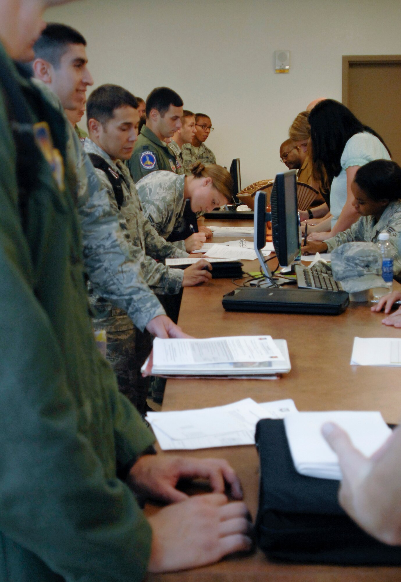 355th Aircraft Maintenance Squadron Airmen process though a reintegration line at Davis-Monthan Air Force Base, Ariz., July 31, 2015. The Airmen recently returned from a 6-month deployment and received reintegration briefings from many base support organizations to include finance, medical, Airman and Family Readiness Center, and the chaplain. (U.S. Air Force photo by Airman 1st Class Ashley N. Steffen/Released)   