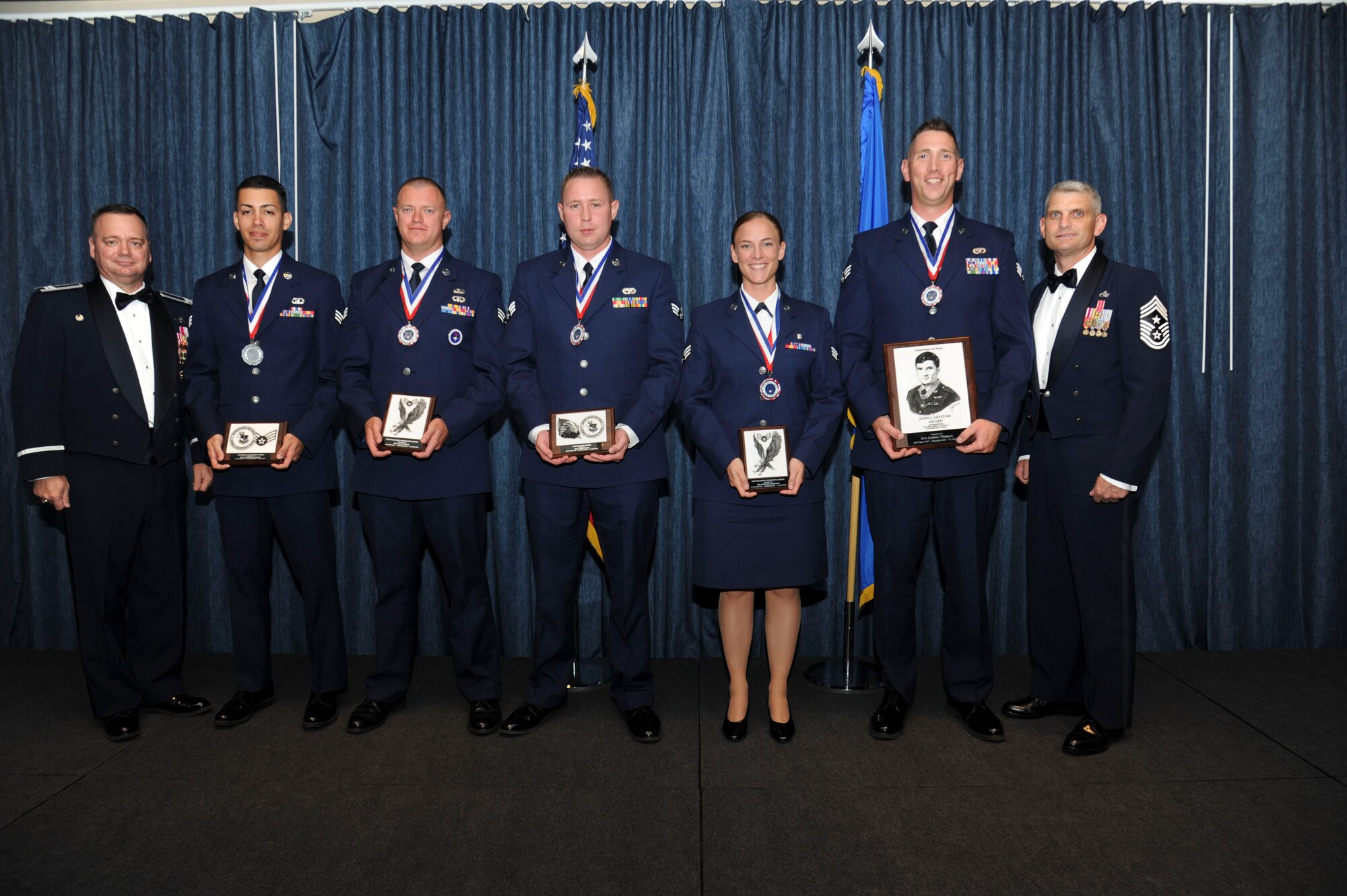 The distinguished graduates from Airman Leadership School Class 15-F pose with Col. Brian McDaniel, 92nd Air Refueling Wing commander, and Chief Master Sgt. Christian Pugh, 92nd ARW command chief, July 31, 2015, at Fairchild Air Force Base, Wash. ALS is a five-week course that develops Airmen into supervisors and focuses on leadership abilities, profession of arms and effective communication in the workplace. (U.S. Air Force photo/Airman 1st Class Nicolo J. Daniello)