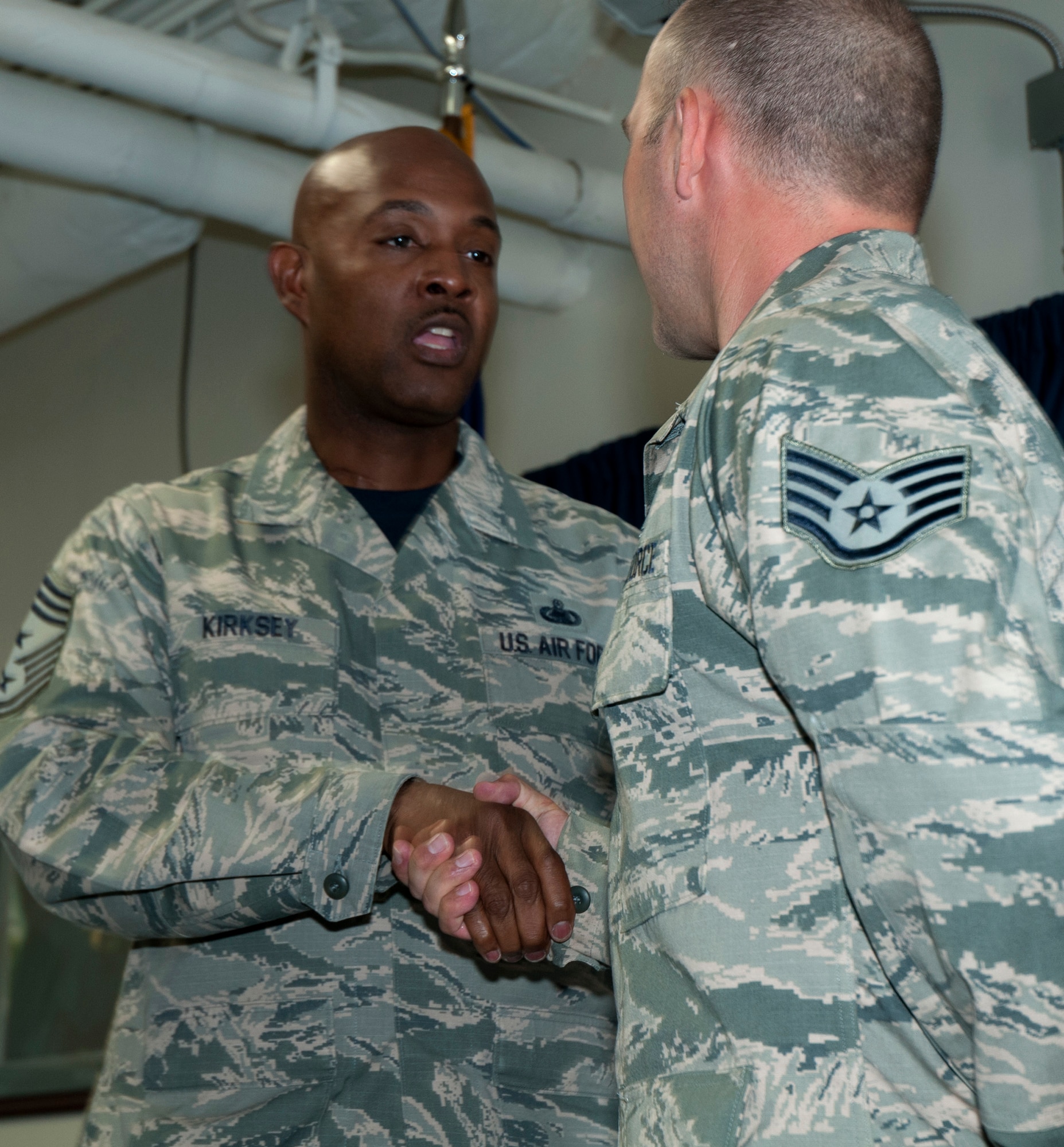 Chief Master Sgt. Cameron Kirksey presents his official coin to Staff Sgt.
Thomas Timney in front of members of the 446th Aircraft Maintenance Squadron
Blue Aircraft Maintenance Unit at Joint Base Lewis-McChord, Wash., Aug. 1,
2015. Timney, a hydraulics system craftsman, said it felt great to be
coined. "I just did everything I was suposed to do that was asked of me and
a little bit more," Timney said. Kirksey, the Air Force Reserve Command
command chief, visited with members of the 446th Airlift Wing Aug. 1-2 to
gain a better perspective on their mission of strategic airlift and airdrop
as well as any issues the Air Force Reservists face. (U.S. Air Force
photo/2nd Lt. Stephen J. Collier)
