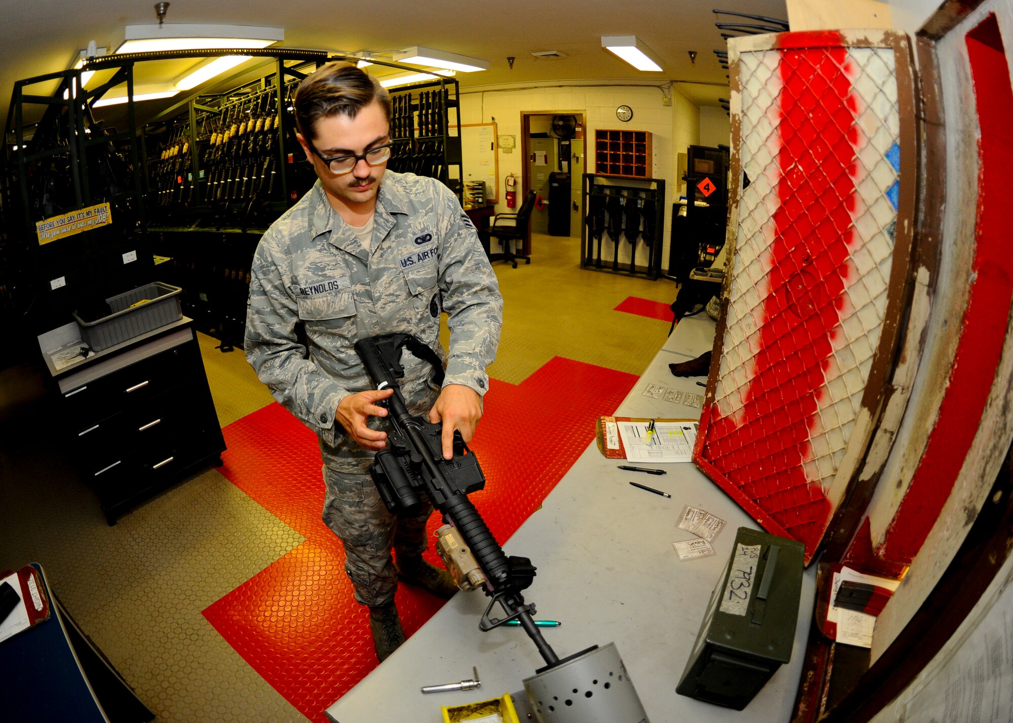 Senior Airman Cody Reynolds, 22nd Security Forces Squadron on-duty armorer, clears an M4 carbine before issuing it to a patrolman, Aug. 4, 2015, at McConnell Air Force Base, Kan. Every weapon is cleared and declared safe in the armory before it is handed off to a Defender at the beginning of their shift. (U.S. Air Force photo by Senior Airman Victor J. Caputo)