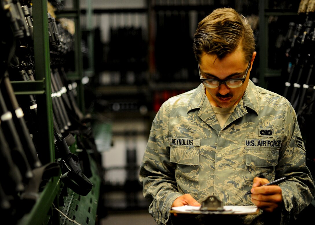 Senior Airman Cody Reynolds, 22nd Security Forces Squadron on-duty armorer, logs the number of weapons inside the 22nd SFS armory, Aug. 4, 2015, at McConnell Air Force Base, Kan. Reynolds keeps track of how many weapons are checked out and how many are in storage during each shift, ensuring accountability for the Defenders’ arms at all times. (U.S. Air Force photo by Senior Airman Victor J. Caputo)