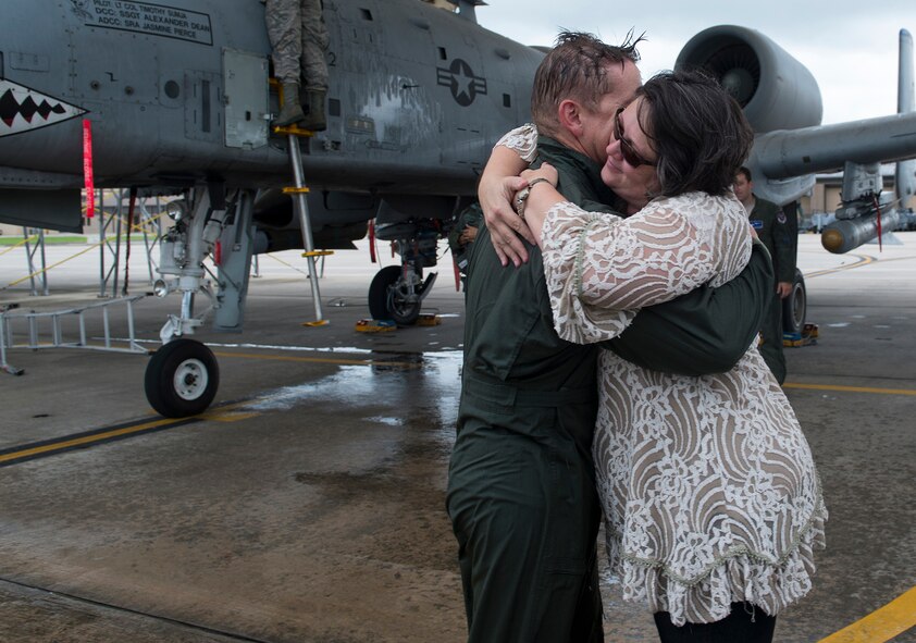 U.S. Air Force Col. Derek Oaks, 23d Fighter Group commander, and his wife, Preot, share a moment after his final flight Aug. 3, 2015, at Moody Air Force Base, Ga. Oaks logged over 4,400 flight hours in C-130 Hercules, C-17A Globemaster III and A-10A/C Thunderbolt II aircraft before retiring Aug. 4, 2015. (U.S. Air Force photo by Airman 1st Class Kathleen D. Bryant/Released)

