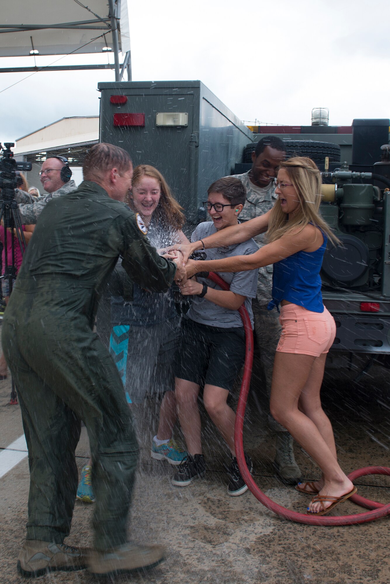 Emma, Laine and Raili Oaks, daughters of U.S. Air Force Col. Derek Oaks, 23d Fighter Group commander, hose down their dad after his final flight Aug. 3, 2015, at Moody Air Force Base, Ga. Oaks retired after 24 years of service on Aug. 4, 2015. (U.S. Air Force photo by Airman 1st Class Kathleen D. Bryant/Released)


