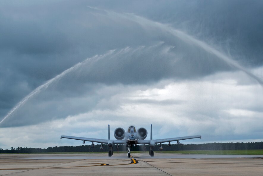 U.S. Air Force Col. Derek Oaks, 23d Fighter Group commander, taxis an A-10C Thunderbolt II under a traditional arc of water Aug. 3, 2015, at Moody Air Force Base, Ga. Taxiing under streams of water from fire trucks is a customary event at the end of a pilot’s final flight. (U.S. Air Force photo by Airman 1st Class Kathleen D. Bryant/Released)

