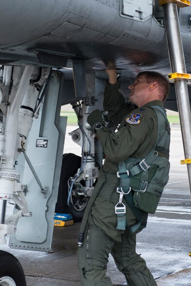 U.S. Air Force Col. Derek Oaks, 23d Fighter Group commander, performs a pre-flight inspection on an A-10C Thunderbolt II Aug. 3, 2015, at Moody Air Force Base, Ga. Oaks conducted his final flight in the A-10 before his retirement from the Air Force. (U.S. Air Force photo by Airman 1st Class Kathleen D. Bryant/Released)

