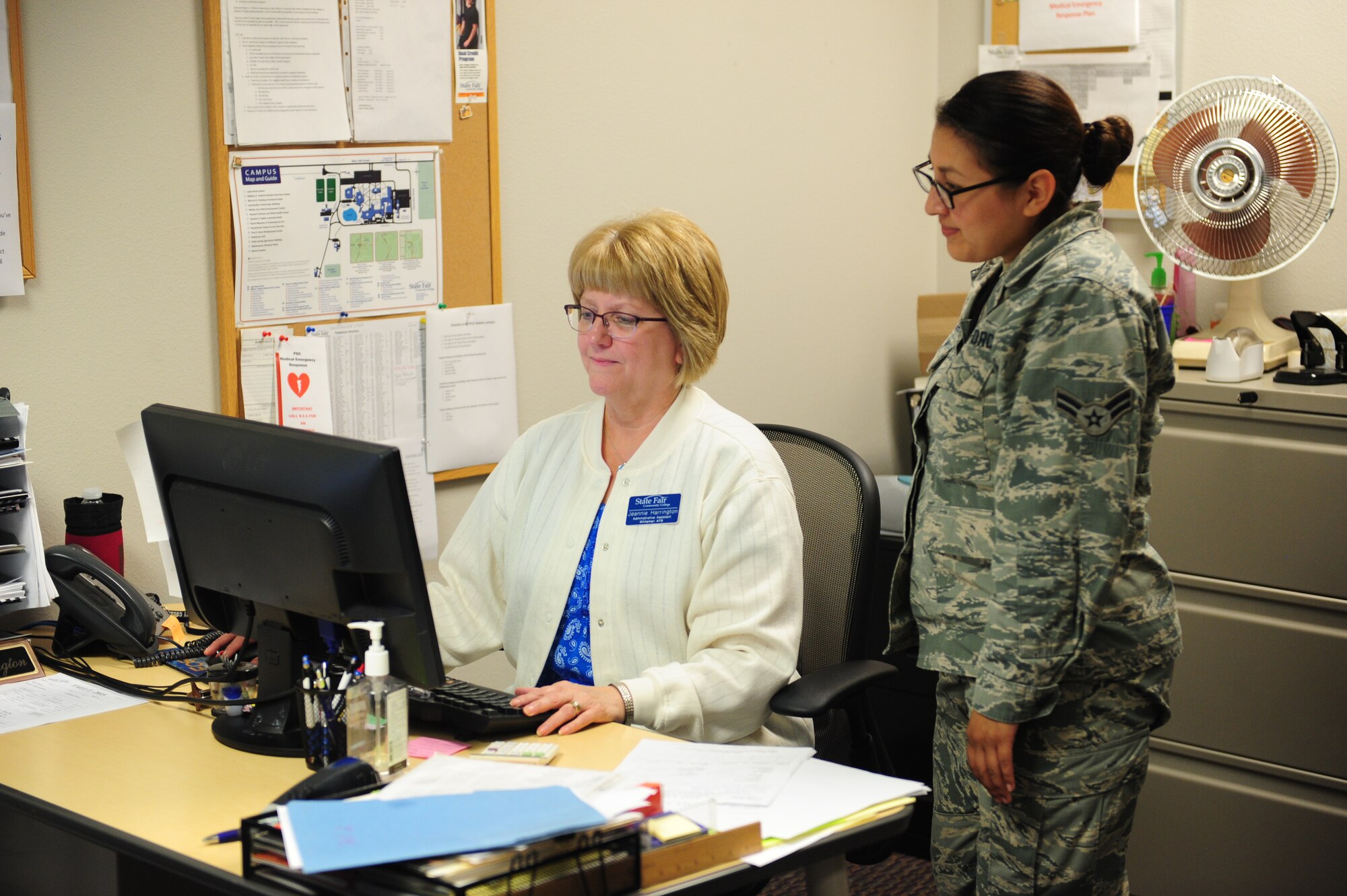 Jeannie Harrington, State Fair Community College administrative assistant, counsels Airman 1st Class Heather De Leon Ventura, 509th Maintenance Group administrator, July 30, 2015, at Whiteman Air Force Base, Mo. After speaking with an education specialist, a service member or dependent can check out the schools available at the Professional Development Center for information on the admission process or counseling on classes. (U.S. Air Force photo by Airman 1st Class Jazmin Smith/Released)