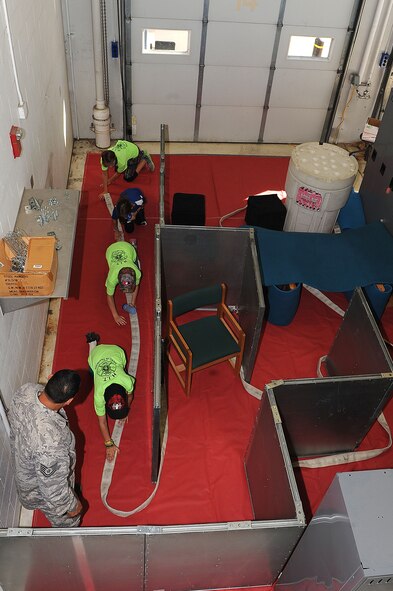 Children crawl through a maze with grey goggles to simulate crawling through a smoke filled room during an interactive event for children and their families called “Hero in Training” July 31, 2015. The event showcased displays from the fire department, security forces squadron, medical group and other base agencies. (U.S. Air Force photo/Senior Airman Kristoffer Kaubisch)