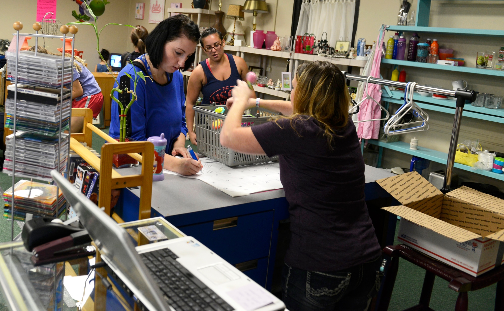 A Team Shaw spouse completes a registration form before collecting her weekly items at The Attic, Aug. 4, 2015, at Shaw Air Force Base, S.C.. The Attic helps Airmen and soldiers ranked E-5 and below by providing no-cost household goods, clothing, and uniforms that can help improve their quality of life. (U.S. Air Force photo by Airman 1st Class Christopher Maldonado/Released)