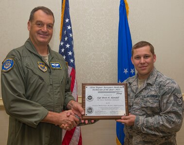 Brigadier Gen.  Kory Cornum, the Air Mobility Command surgeon general, presents the non-commissioned officer Olson-Wegner Aerospace Medicine Technician of the Year award to Staff Sgt. Brett Randall, an independent duty medical technician with the 628th Medical Group,  July 30, 2015, at the Charleston Club on Joint Base Charleston, S.C. (U.S. Air Force photo/ Thomas T. Charlton)