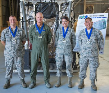 (From left to right) Master Sgt. Eric Ragan, the superintendent of the 437th Maintenance Group, Maj. Stephen Yarboro, a flight nurse with the 315th Aeromedical Evacuation Squadron, Staff Sgt. Jessica Dickard, a medical logistic technician from the 628th Medical Group and Master Sgt. Paolo Ablang, a bioenvironmental engineering technician from the 628th MDG were all presented with “Real Pro” awards by Brig. Gen. Kory Cornum, the Air Mobility Command surgeon general  on July 30, 2015, in building 575 on the flight line at Joint Base Charleston, S.C. (U.S. Air Force photo/ Thomas T. Charlton)