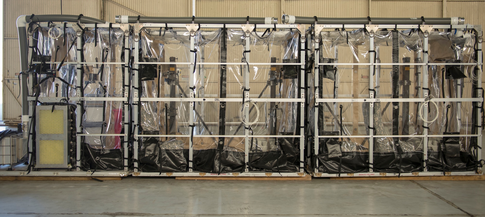 The Transport Isolation System was described to Brig. Gen. Kory Cornum, the surgeon general for Air Mobility Command, on July, 30, 2015 in building 575 on the flight line at Joint Base Charleston, S.C.  The TIS is an asset the Department of Defense uses to safely transport patients with highly contagious diseases such as Severe Acute Respiratory Syndrome or the Ebola Virus. (U.S. Air Force photo/ Thomas T. Charlton)