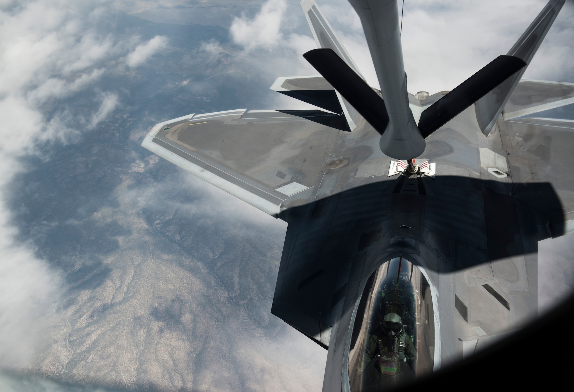 An F-22A Raptor from the 95th Fighter Squadron stationed with the 325th Fighter Wing, Tyndall Air Force Base, Florida, receives jet fuel from a refueling boom July 31, 2015, over the Nevada Test and Training Range. More than 20 units from across the globe are at Nellis AFB to participate in Red Flag 15-3. The jet was refueled by a KC-135 Stratotanker from the 93rd Air Refueling Squadron from Fairchild AFB, Washington. Since its establishment in 1975, Red Flag has played host to military units from more than 30 different countries. (U.S. Air Force photo by Senior Airman Brittany A. Chase)
