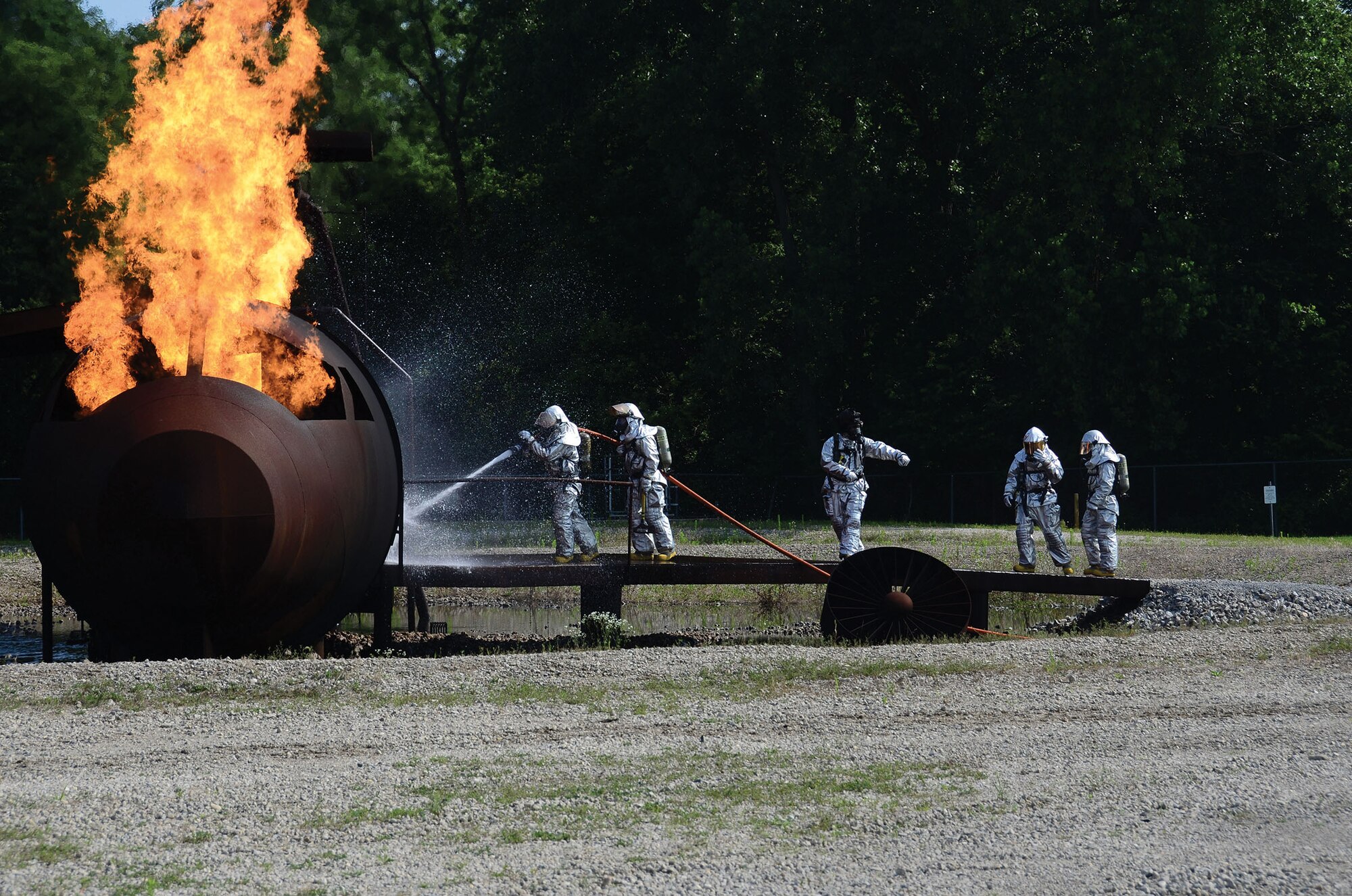WRIGHT-PATTERSON AIR FORCE BASE, Ohio – Fire and Emergency personnel from the 445th Civil Engineer Squadron practice fire pit and structural training July 11, 2015. The annual training allows firefighters to practice incident-command and emergency scenarios in a controlled learning environment. (U.S. Air Force photo/Senior Airman Joel McCullough)