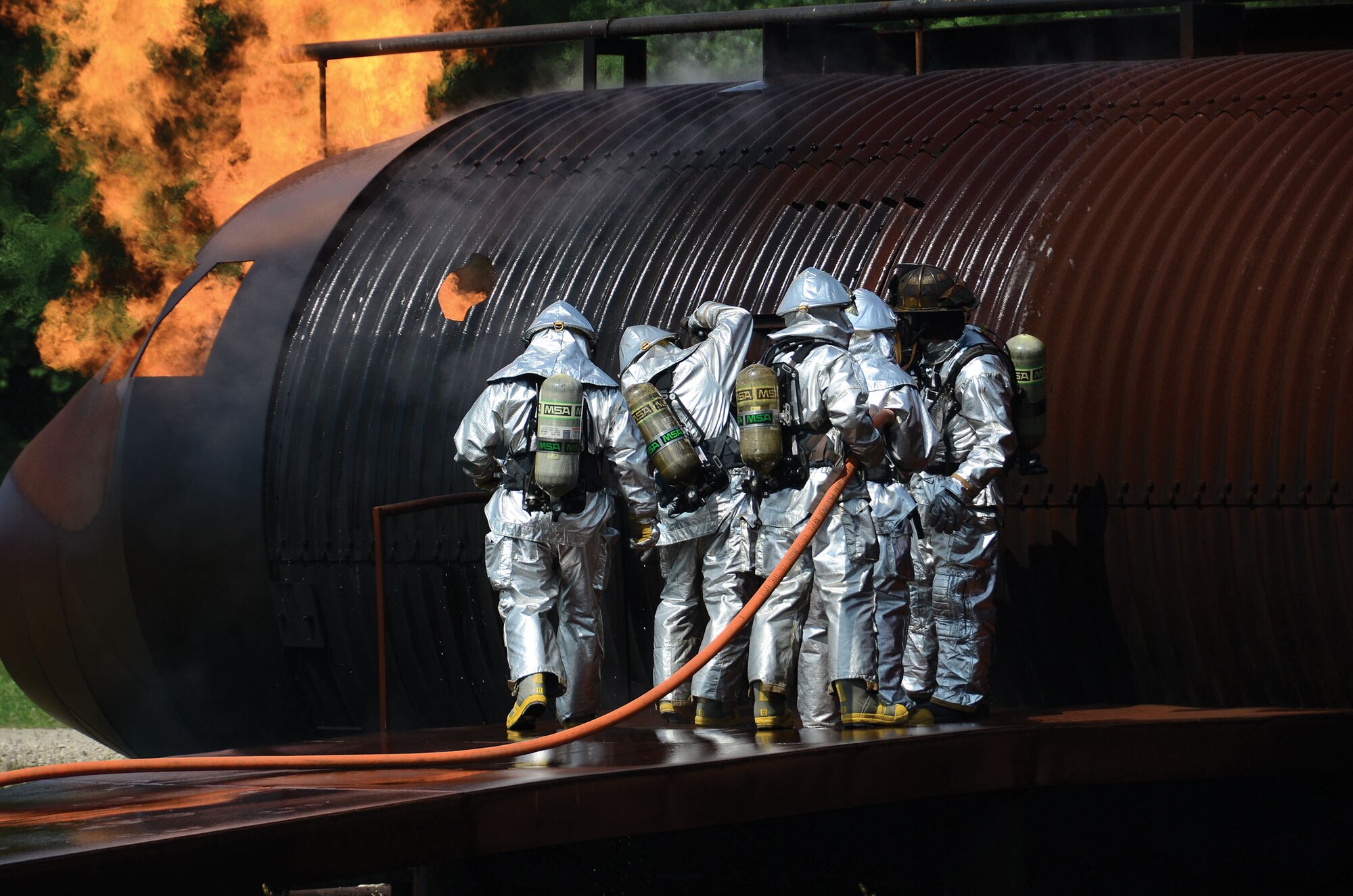 WRIGHT-PATTERSON AIR FORCE BASE, Ohio – Fire and Emergency personnel from the 445th Civil Engineer Squadron practice fire pit and structural training July 11, 2015. The annual training allows firefighters to practice incident-command and emergency scenarios in a controlled learning environment. (U.S. Air Force photo/Senior Airman Joel McCullough)
