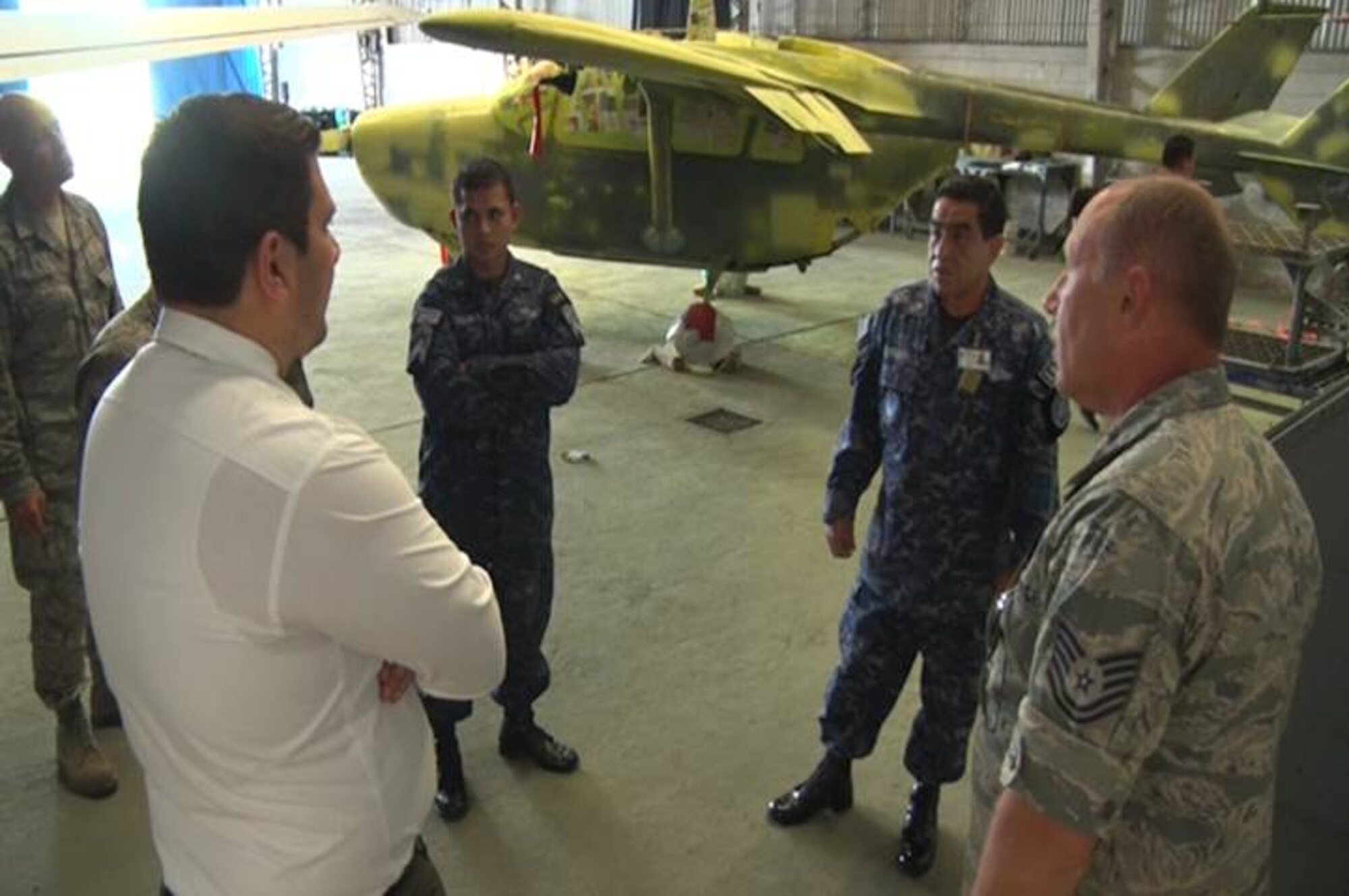 Tech. Sgt. Glen Patterson, 157th Aircraft Maintenance Squadron aircraft structural maintenance technician communicates with members from the Salvadorian Air Force using a translator. Airmen from the 157 AMS spent a week in El Salvador, July 21 through 24, 2015, as part of the on-going New Hampshire state partnership program with El Salvador. (U.S. Air National Guard photo by Tech. Sgt. Erica Rowe) 