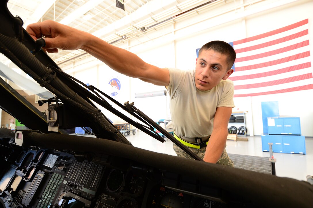 U.S California Air National Guardsman, Senior Airman Juan Ortiz, crewchief with the 129th Aircraft Maintenance Squadron, Moffett Federal Airfield, Calif., repairs a cracked windshield on a HH-60 Pavehawk helicopter during Angel Thunder 2015 exercises at Davis-Monthan AFB, Ariz., June 2, 2015. The windshield was damaged due to flying debris. (U.S. Air National Guard photo by Senior Airman Rachael Kane/Released)