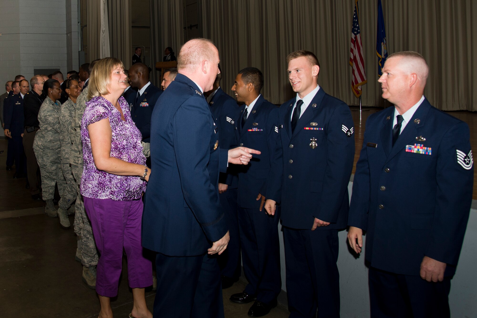 Commanders and attendees congratulate Airmen who pinned on their next rank at the enlisted promotion ceremony July 30. (U.S. Air Force photo by Chris Higgins)