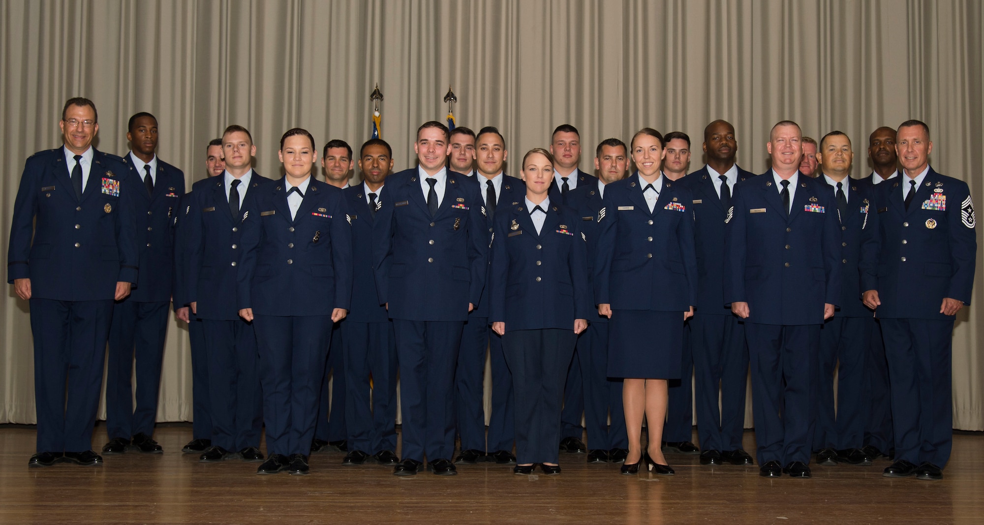 Newly promoted Airmen take a group picture at the enlisted promotion ceremony at the base theater July 30. (U.S. Air Force photo by Chris Higgins)