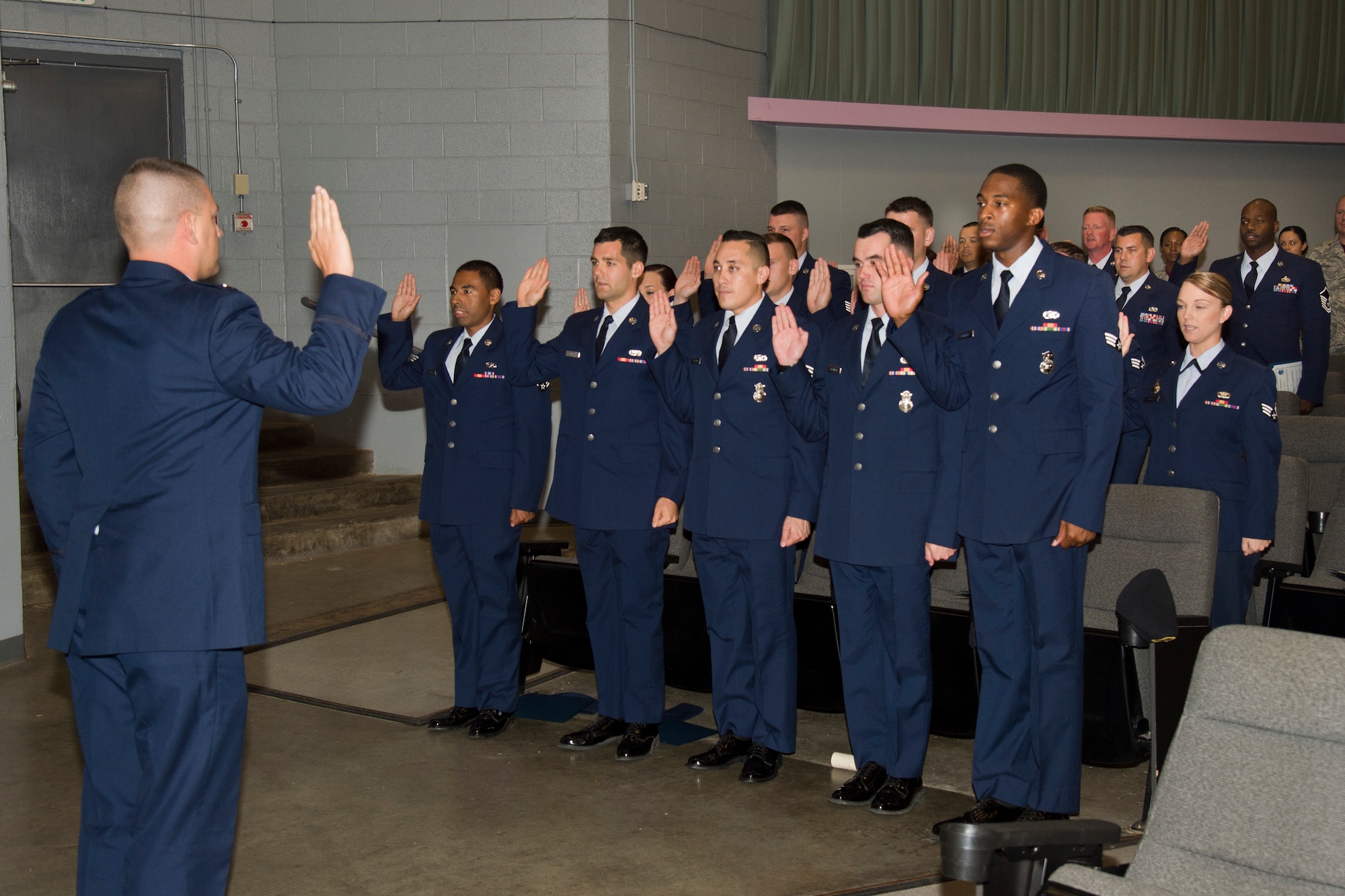 Edwards Airmen reaffirm their oath at the monthly enlisted promotion ceremony held July 30 at the base theater. (U.S. Air Force photo by Chris Higgins)