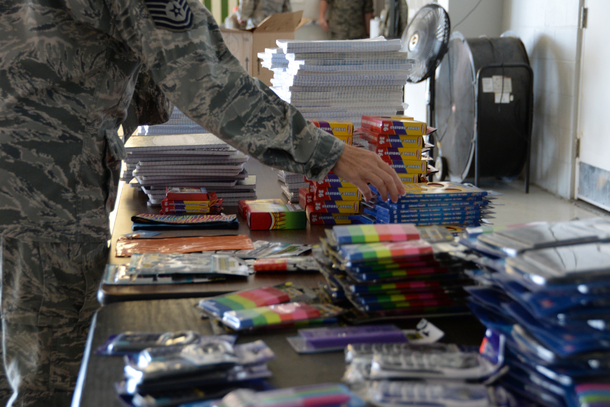 U. S. Air Force Airmen browse school supplies donated to military personnel by local community members through Operation Home front: Back to School Brigade. This operation gives back to those who serve the community as a member of the armed services. (U.S. Air National Guard photo by Airman 1st Class Kevin D. Schulze/Released)