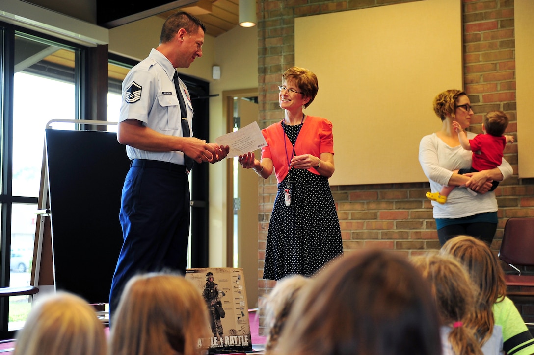 U.S. Air Force Master Sgt. Norman J. Drzewiecki, an information protection manager with the 180th Fighter Wing, receives a certificate of appreciation from Patti Lusher, a librarian at the Waterville Branch Library, after speaking July 28, 2015 during the “Real Superheroes” event in Waterville, Ohio. Drzewiecki focused most of his talk on the importance of making the right choices in life. (Air National Guard photo by Staff Sgt. Shane Hughes/Released)