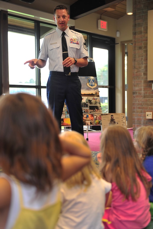 U.S. Air Force Master Sgt. Norman J. Drzewiecki, an information protection manager with the 180th Fighter Wing, speaks to children July 28, 2015 during the “Real Superheroes” event at the Waterville Branch Library in Waterville, Ohio. Drzewiecki was one of four guest speakers for the event, which highlighted civil service jobs in the community. (Air National Guard photo by Staff Sgt. Shane Hughes/Released)