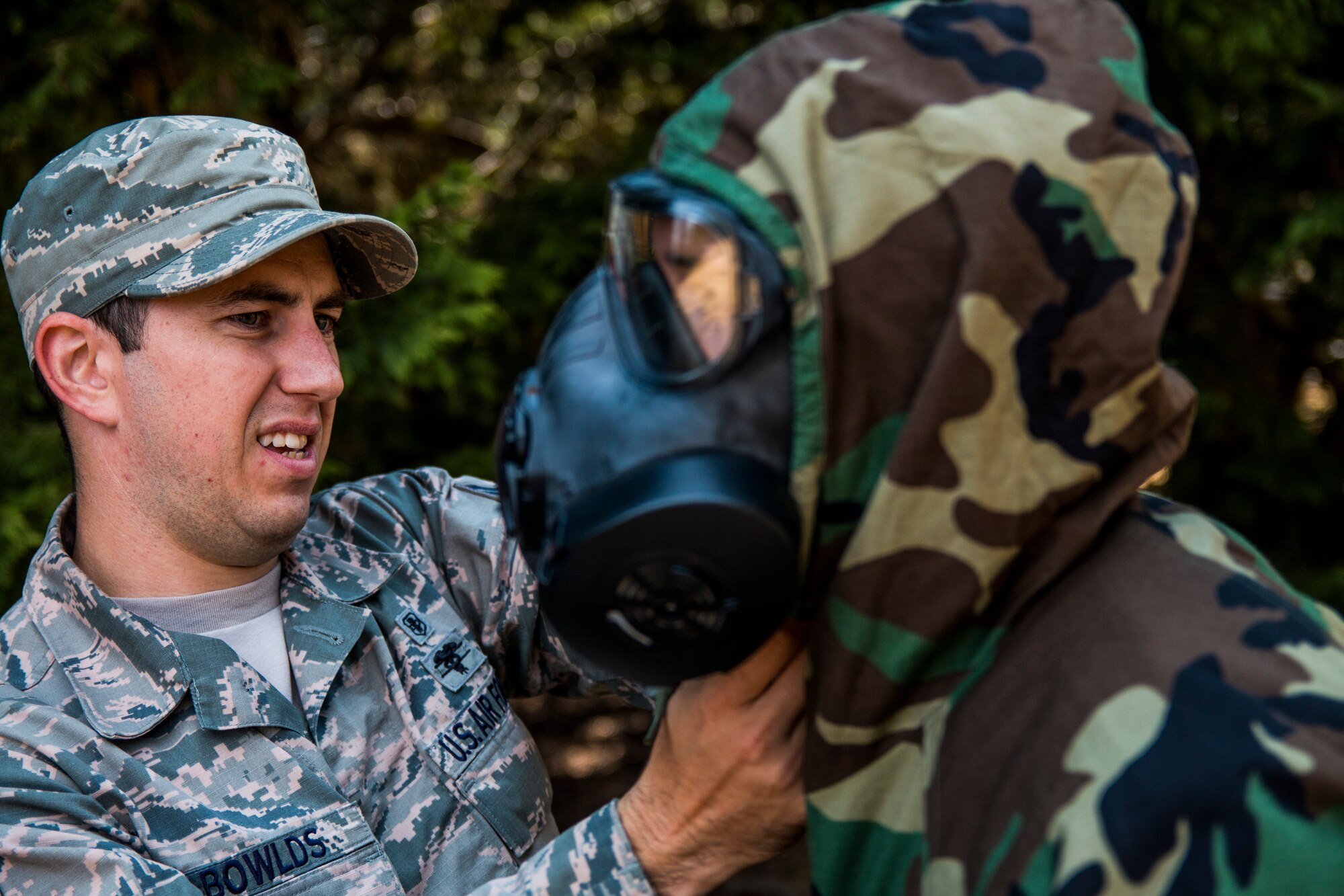 SrA Christopher Bowlds, 446th Aeromedical Staging Squadron medic, checks an Airman’s Mission Oriented Protective Posture gear in preparation for the annual Expert Field Medical Badge test at McChord Field, Wash., Aug. 2, 2015. The Expert Field Medical Badge is a unique distinction worn only by the most battle-ready and elite medical personnel in the military. Every year at Joint Base Lewis-McChord, Wash., a  two-week intensive testing event is set up to qualify eligible service members from around the country for the right to wear the coveted badge. (U.S. Air Force photo by Senior Airman Daniel Liddicoet)