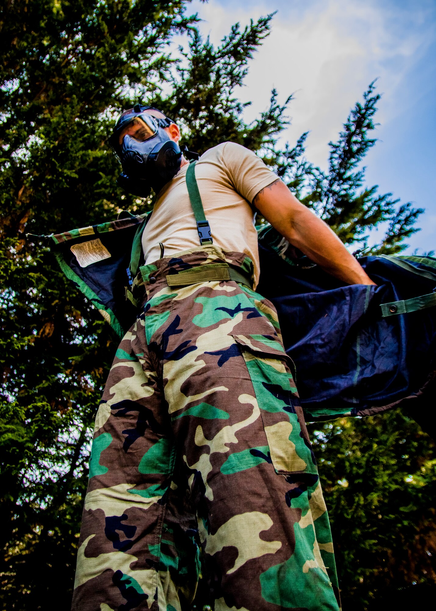 Staff Sgt. Kyle Bosshardt, 446th Aeromedical Staging Squadron medic, dons Mission Oriented Protective Posture gear in preparation for the annual Expert Field Medical Badge test at McChord Field, Wash., Aug. 2, 2015. The Expert Field Medical Badge is a unique distinction worn only by the most battle-ready and elite medical personnel in the military. Every year at Joint Base Lewis-McChord, Wash., a  two-week intensive testing event is set up to qualify eligible service members from around the country for the right to wear the coveted badge. (U.S. Air Force photo by Senior Airman Daniel Liddicoet)