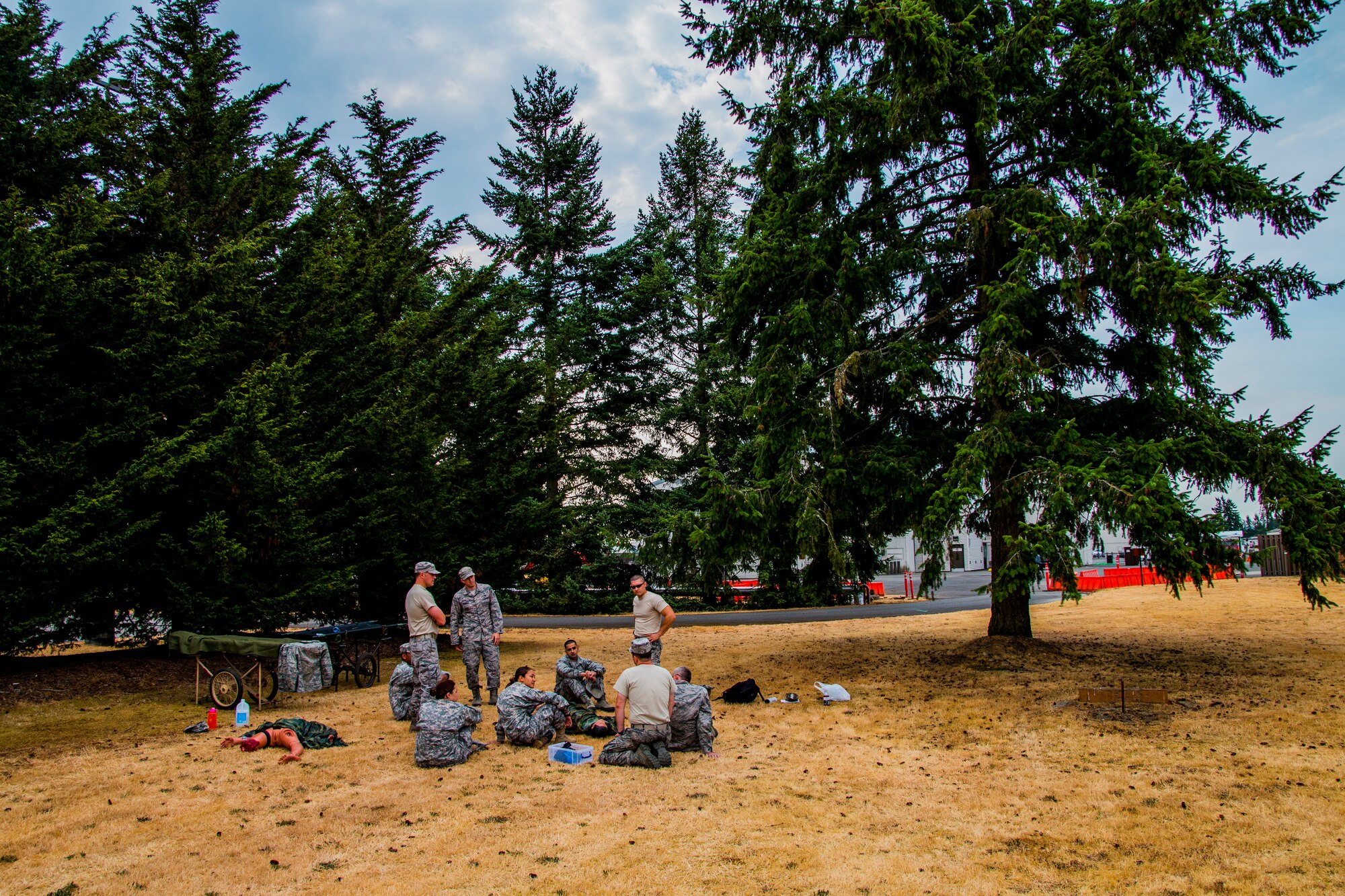 Medics from the 446th Aeromedical Staging Squadron gather to train on various medical procedures in preparation for the annual Expert Field Medical Badge test at McChord Field, Wash., Aug. 2, 2015. The Expert Field Medical Badge is a unique distinction worn only by the most battle-ready and elite medical personnel in the military. Every year at Joint Base Lewis-McChord, Wash., a  two-week intensive testing event is set up to qualify eligible service members from around the country for the right to wear the coveted badge. (U.S. Air Force photo by Senior Airman Daniel Liddicoet)