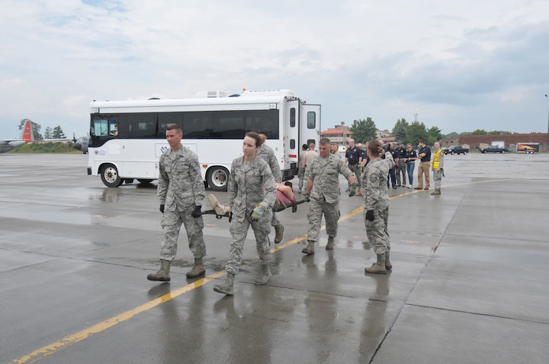 Members of the New York Air National Guard's 139th Aeromedical Evacuation Squadron, the Tennessee Air National Guard's 118th Medical Group, and the Albany Stratton Veterans Affairs Medical Center carry "patients", made up from the New York Civil Air Patrol, from the staging area tent to an LC-130 Hercules aircraft during an exercise at Stratton Air National Guard Base, Scotia, New York. The National Disaster Medical System Exercise, held July 27, 2015 through Aug. 2, 2015, demonstrated interagency partnership among the Department of Health and Human Services, the Department of Homeland Security, the Department of Defense, and the Department of Veterans Affairs and the instrumental role of aeromedical evacuation in the national emergency response and national defense frameworks. (U.S. Air National Guard photo by Master Sgt. William Gizara/Released)