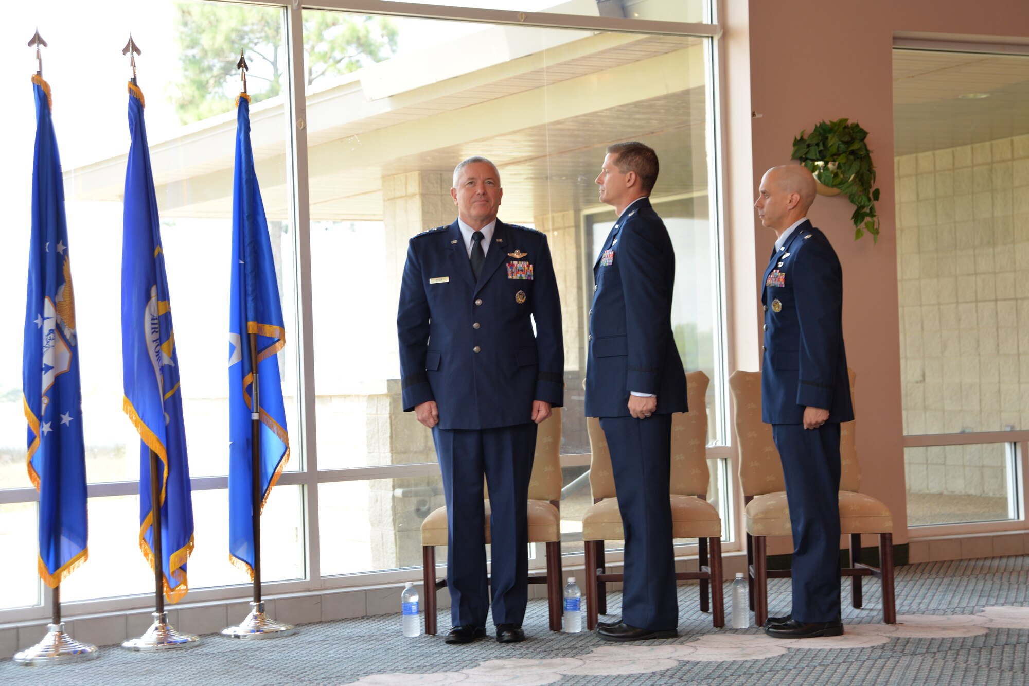 As Ruffles and Flourishes honors play at the beginning of the Air Force Rescue Coordination Center change of command ceremony  July 29, Lt. Gen. William Etter, Commander, Continental U.S. Aerospace Defense Command Region – 1 st Air Force, Air Forces Northern, stands at attention along with Lt. Col. Ian Kemp, departing AFRCC commander, and Lt. Col. James Woosley , incoming commander. (U.S. Air Force photo released/Capt. Jared Scott)