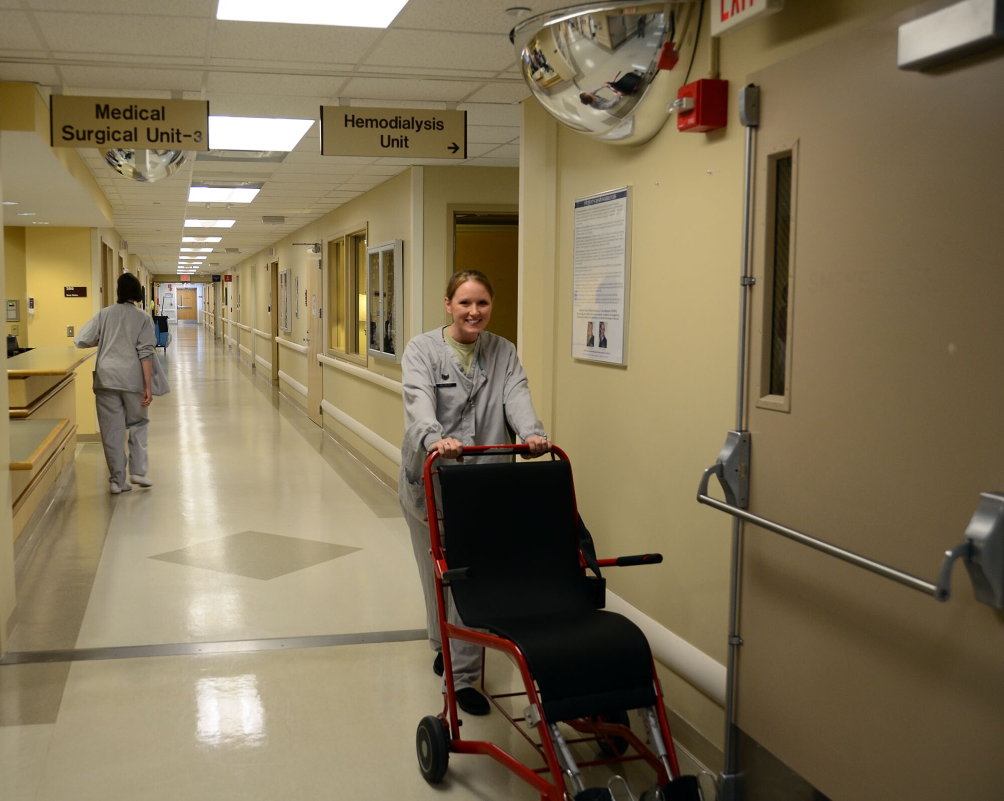 WRIGHT-PATTERSON AIR FORCE BASE, Ohio – Tech. Sgt. Michelle Helregel, 445th Aeromedical Staging Squadron aerospace medicine services craftsman, pushes a specialized wheel chair designed for supporting individuals with leg casts while performing her annual tour at the Wright Patterson AFB Medical Center July 16, 2015. Active duty Airmen and reservists in the same career field had the opportunity to share learning experiences during annual tour performed between ASTS and the 88th Medical Group July 11-25. (U.S. Air Force photo/Senior Airman Joel McCullough)