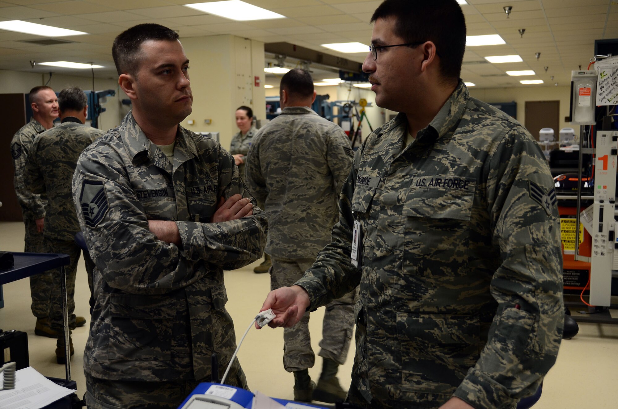 WRIGHT-PATTERSON AIR FORCE BASE, Ohio – Biomedical repair technicians Master Sgt. Craig Stevenson, 445th Aeromedical Staging Squadron and Senior Airman Richard Monroe, 88 Air Base Wing Medical Group, discuss the current situation with a malfunctioning defibrillator in the medical equipment repair center at the Wright Patterson AFB Medical Center July 16, 2015. Active duty Airmen and reservists in the same career field had the opportunity to share learning experiences during annual tour performed between ASTS and the 88th Medical Group July 11-25. (U.S. Air Force photo/Senior Airman Joel McCullough)