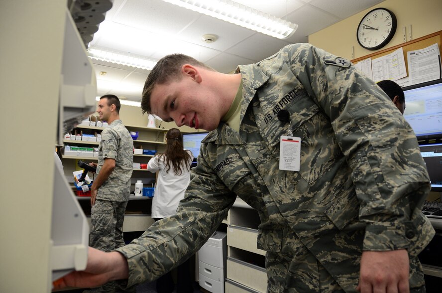 WRIGHT-PATTERSON AIR FORCE BASE, Ohio – Airman John Pappas III, 445th Aeromedical Staging Squadron pharmacy journeyman, fills and prepares prescriptions so that they are readily available for patient pick-up while performing his two-week annual tour July 16, 2015 at the Wright Patterson AFB Medical Center. Active duty Airmen and reservists in the same career field had the opportunity to share learning experiences during annual tour performed between ASTS and the 88th Medical Group July 11-25. (U.S. Air Force photo/Senior Airman Joel McCullough)