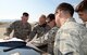 Members from the 9th Civil Engineer Squadron Explosive Ordinance Disposal Flight and a member from the 173rd Fighter Wing looks at an airfield map at Kingsley Field Air National Guard Base, Oregon, July 31, 2015. The EOD technicians received hands on training and provided safety support for Sentry Eagle 15 July 30 to Aug. 2, 2015. (U.S. Air Force photo by Airman 1st Class Ramon A. Adelan)