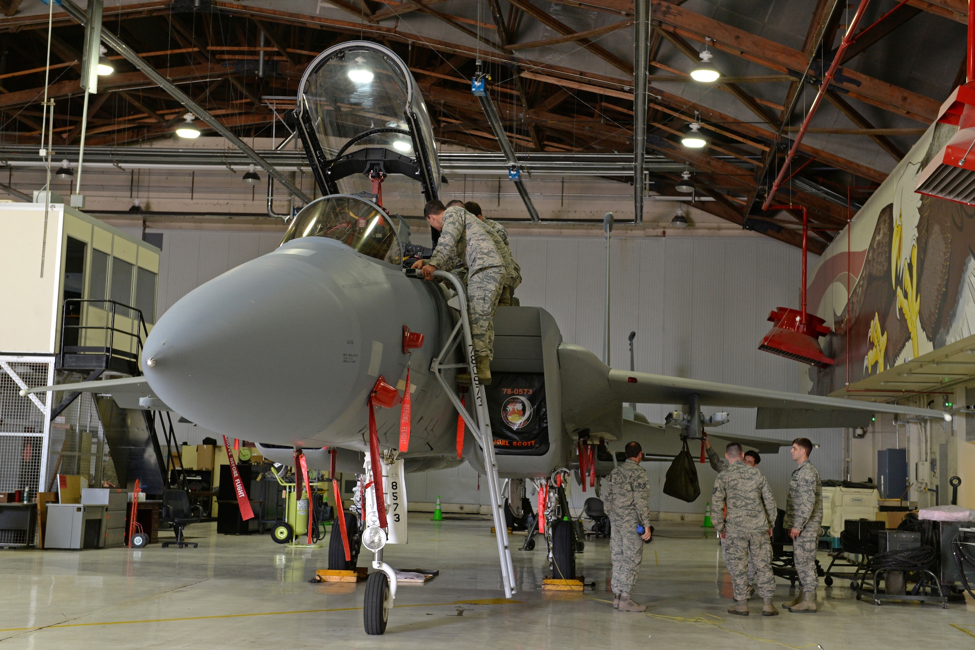 Members from the 9th Civil Engineer Squadron Explosive Ordinance Disposal Flight, train with the 173rd Fighter Wing, to learn egress protocol on an F-15 Eagle at Kingsley Field Air National Guard Base, Oregon, July 30, 2015. The EOD technicians received hands on training and provided safety support for Sentry Eagle 15 July 30 to Aug. 2, 2015. (U.S. Air Force photo by Airman 1st Class Ramon A. Adelan)