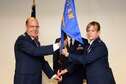 Lt. Col. Jennifer Fitch, commander of the 911th Operations Support Squadron, accepts the guideon from 911th Operations Group Commander Col. Jeff Potts at the Pittsburgh International Airport Air Reserve Station, August 1, 2015. Fitch, who was stationed in locations like Japan and South Carolina, assumed command of the 911th OSS over the August unit training assembly. (U.S. Air Force photo by Senior Airman Marjorie A. Bowlden)