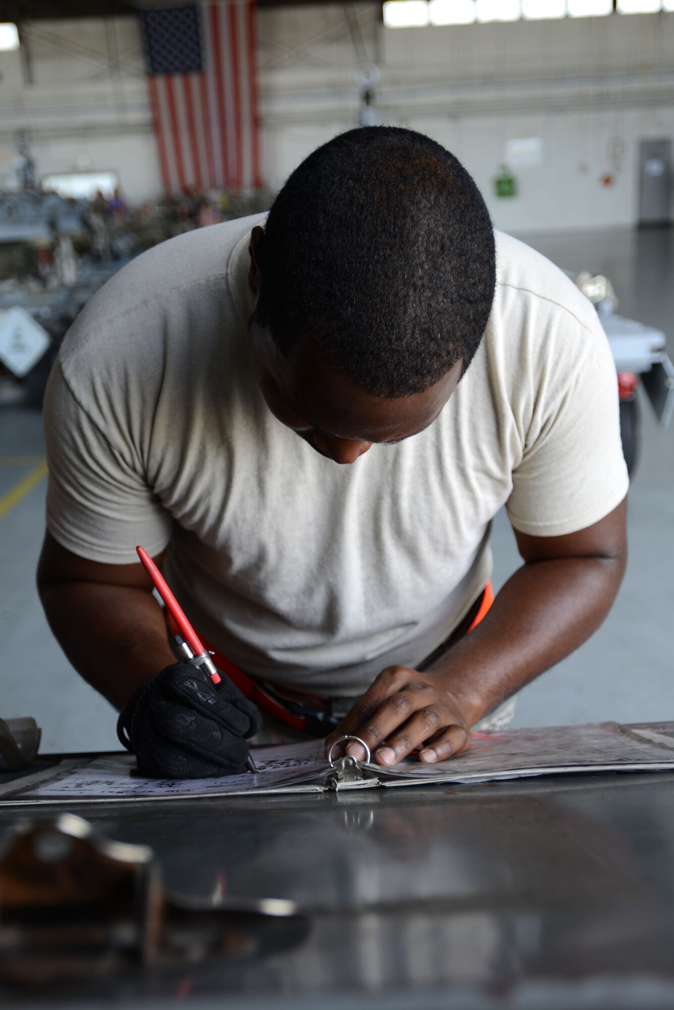 U.S. Air Force Senior Airman LaMontra McMurtry, 20th Aircraft Maintenance Squadron, 77th Aircraft Maintenance Unit weapons load crew member, writes down information during a weapons load crew of the quarter competition at Shaw Air Force Base, S.C., July 31, 2015. During the load competition, Airmen completed checklists to ensure tasks were done safely and correctly. (U.S. Air Force photo by Airman 1st Class Kelsey Tucker/Released)