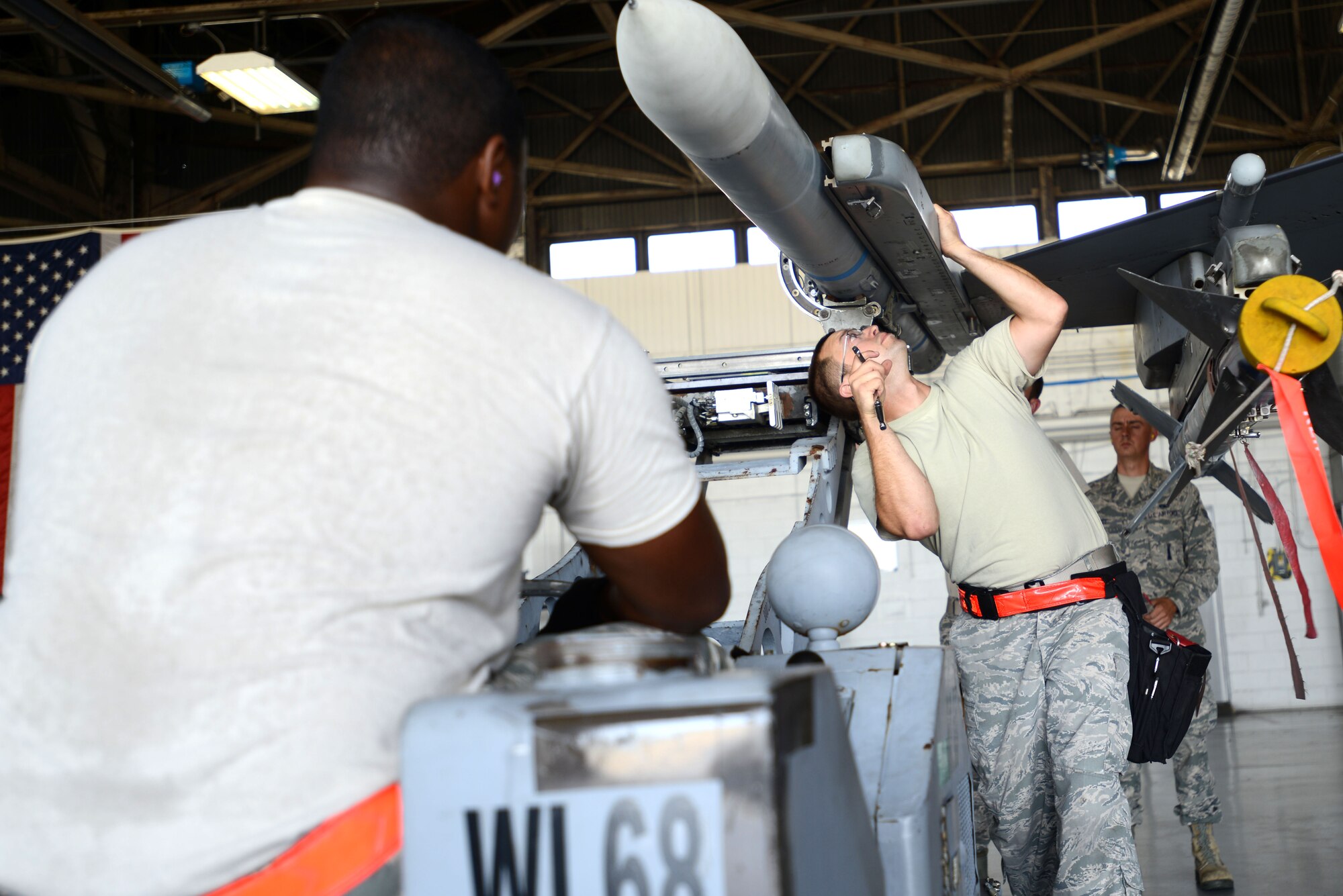 U.S. Air Force Staff Sgt. Bryan Tune, 20th Aircraft Maintenance Squadron, 77th Aircraft Maintenance Unit weapons load crew member, ensures munitions are loaded correctly during a weapons load crew of the quarter competition at Shaw Air Force Base, S.C., July 31, 2015. The standard time to load the munitions is 38 minutes. (U.S. Air Force photo by Airman 1st Class Kelsey Tucker/Released)
