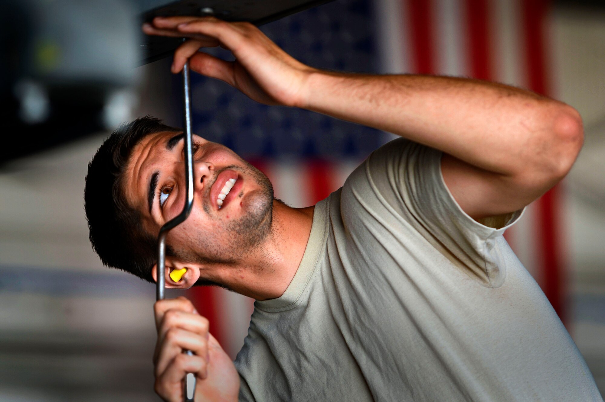 U.S. Air Force Senior Airman Christopher Crawford, 20th Aircraft Maintenance Squadron, 79th Aircraft Maintenance Unit weapons load crew member, tightens a bolt during a weapons load crew of the quarter competition at Shaw Air Force Base, S.C., July 31, 2015.  Crawford and his crew loaded three munitions during the competition: the AIM-120, ADM-160b, and AIM-9M. (U.S. Air Force photo by Senior Airman Jensen Stidham/Released)
