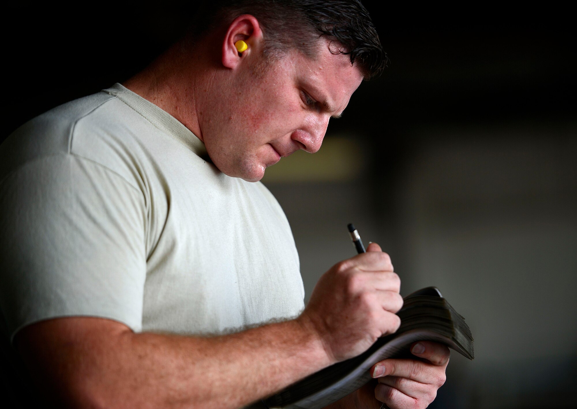 U.S. Air Force Staff Sgt. Mitchell Baker, 20th Aircraft Maintenance Squadron, 79th Aircraft Maintenance Unit weapons load crew member, marks his checklist during a weapons load crew of the quarter competition at Shaw Air Force Base, S.C., July 31, 2015. For each munition loaded, a series of tasks must be completed to ensure safety before moving on to the next weapon. (U.S. Air Force photo by Senior Airman Jensen Stidham/Released)
