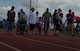 Select participants take the first lap to start the Relay for Life event at the outdoor track on Spangdahlem Air Base, Germany, July 31, 2015. The first lap, also known as the survivors’ lap, features all cancer survivors at the event being cheered on by other participants lined around the track, celebrating the survivors’ victory over cancer. (U.S. Air Force photo by Airman 1st Class Luke Kitterman/Released) 